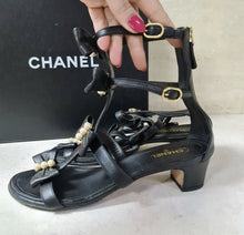 Load image into Gallery viewer, Chanel Camellia Pearl Black Leather Heels Sandals Size 37,5 - LuxyBrand
